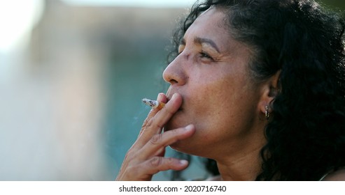 Hispanic Anxious Woman Smoking Cigarette.