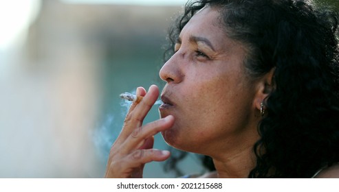 Hispanic Anxious Woman Smoking Cigarette.