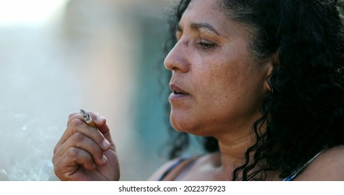 Hispanic Anxious Woman Smoking Cigarette.