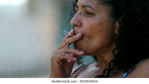 Hispanic Anxious Woman Smoking Cigarette.