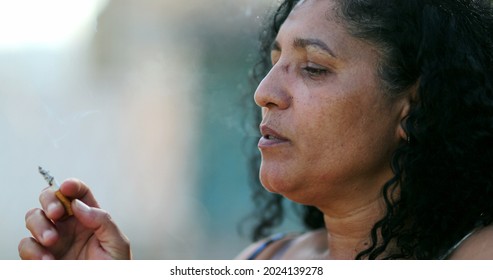 Hispanic Anxious Woman Smoking Cigarette.