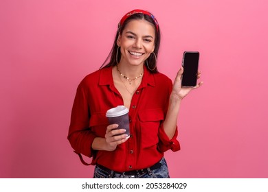 Hispanic Beautiful Woman In Red Shirt Smiling Holding Smartphone Drinking Coffee On Pink Studio Background Isolated Wearing Headband