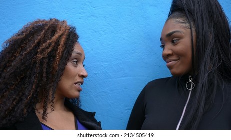 A Hispanic Black Parent In Conversation With A Teen Daughter Outside In Urban Street