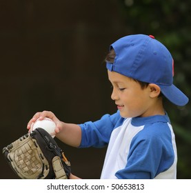 Hispanic Boy Playing With Baseball And Glove