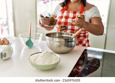 Hispanic Brunette Woman Preparing Chocolate Cake At The Kitchen