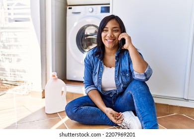 Hispanic Brunette Woman Waiting For Laundry Speaking On The Phone At Laundry Room