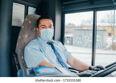 hispanic bus driver with mask in the protecting gloves on his hand in bus to protect himself from the coronavirus epidemic. Pandemic coronavirus 2020. Quarantine.Virus concept. Epidemic infection.
