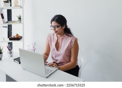 hispanic business woman working in her desk at office in Mexico Latin America	