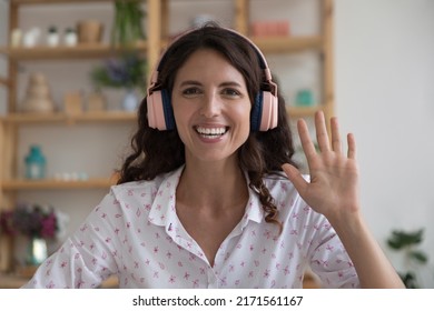 Hispanic Businesswoman Wear Wireless Headphones Smiling Look At Camera Greets Client Or Recruiter Start Job Interview, Head Shot Portrait. Distance Negotiations, Modern Tech, Video Call Event Concept