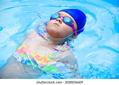 A Hispanic Child From Colombia Swimming In A Pool