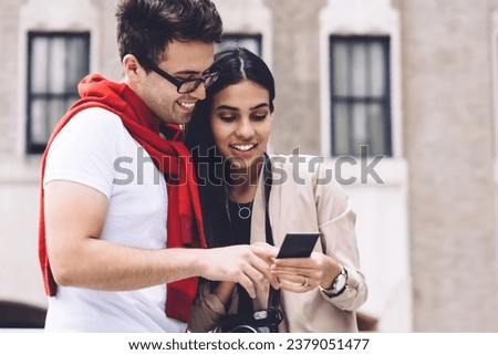 Hispanic couple bonding and looking at printed photo