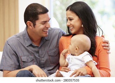 Hispanic Couple At Home With Baby