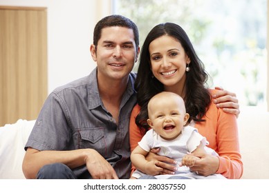 Hispanic Couple At Home With Baby