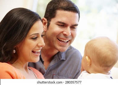 Hispanic Couple At Home With Baby