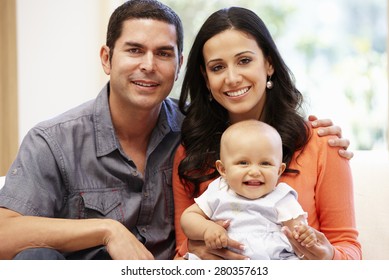 Hispanic Couple At Home With Baby