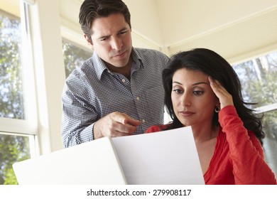 Hispanic Couple Working In Home Office