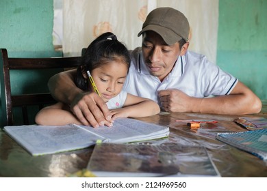 Hispanic Dad Helping His Little Daughter Do Her Homework - Teacher Teaching Little Girl To Read And Write - Mayan Family At Home