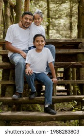 Hispanic Dad And Sons Enjoying Nature In The Park - Young Father With His Children Smiling At Camera