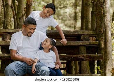 Hispanic Dad And Sons Enjoying Nature In The Park - Young Father With His Children Outdoors Having Fun