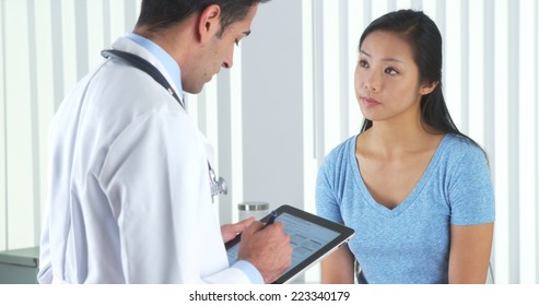 Hispanic Doctor Asking Asian Patient Questions