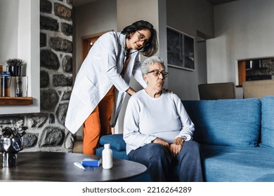 Hispanic Elderly Woman With Doctor Or Nurse During Home Visit In Mexico Latin America