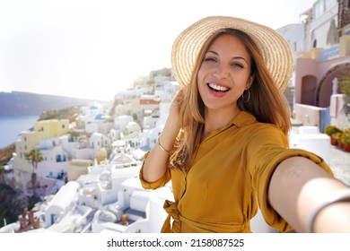 Hispanic exuberant fashion woman having fun taking self portrait on sunset in Santorini Island, Greece - Shutterstock ID 2158087525