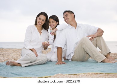 Hispanic Family With 9 Year Old Daughter On Beach Blanket