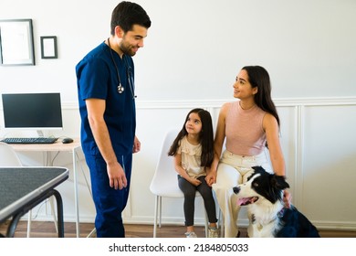 Hispanic Family Bringing A Border Collie Dog For A Check Up To The Veterinarian At The Animal Hospital