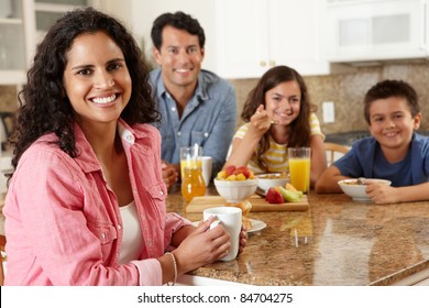 Hispanic family eating breakfast
