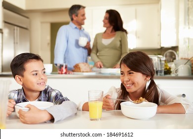 Hispanic Family Eating Breakfast At Home Together