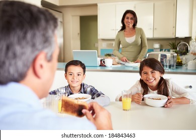 Hispanic Family Eating Breakfast At Home Together