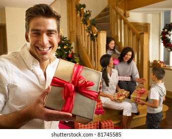 Hispanic Family Exchanging Gifts At Christmas