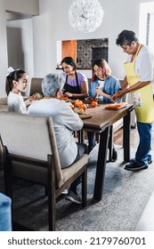 Hispanic Family Of Female Three Generations, Grandmother And Granddaughter Cooking At Home In Mexico Latin America