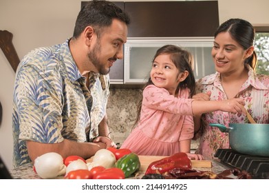 Hispanic Family Happily Cooking. Modern And Young Couple Cooking Together At Home.
Latin Family.