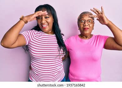 Hispanic Family Of Mother And Daughter Hugging Together With Love Stressed And Frustrated With Hand On Head, Surprised And Angry Face 