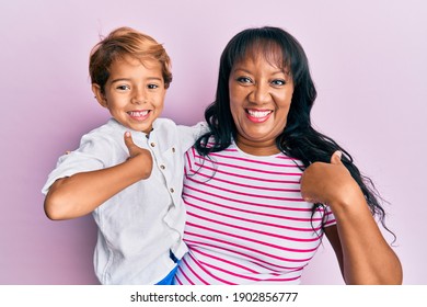 Hispanic Family Of Mother And Son Hugging Together With Love Pointing Finger To One Self Smiling Happy And Proud 