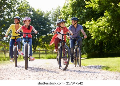 Hispanic Family On Cycle Ride In Countryside