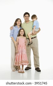 Hispanic Family Standing Against White Background.