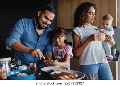 Hispanic father with child daughter preparing breakfast at kitchen in Mexico Latin America