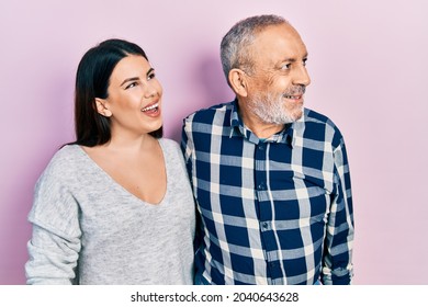 Hispanic Father And Daughter Wearing Casual Clothes Looking Away To Side With Smile On Face, Natural Expression. Laughing Confident. 