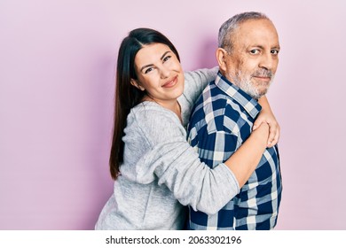 Hispanic Father And Daughter Wearing Casual Clothes Looking To Side, Relax Profile Pose With Natural Face And Confident Smile. 