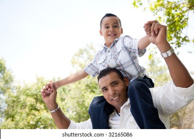 Hispanic Father And Son Having Fun Together In The Park.