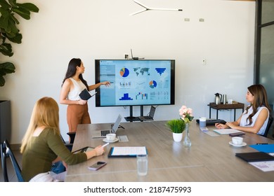 Hispanic Female Boss Giving A Work Presentation To The All Women Work Team In The Meeting Room