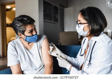 Hispanic Female Doctor Giving Covid Vaccine To Senior Woman In Her Home In Mexico Latin America