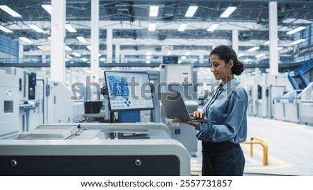 Hispanic Female Engineer Using Laptop To Control Soldering Jet Printer On Electronics Factory. Woman Working On Production Of Innovative Circuit Boards For Complex Artificial Intelligence Systems.