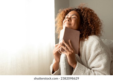 Hispanic female making wish in personal journal. Multiracial woman feeling happy and grateful after writing in manifesting diary. Copy space. Lifestyle concept. - Powered by Shutterstock