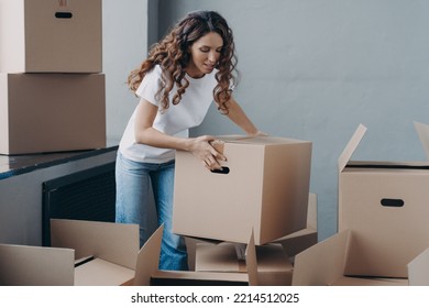 Hispanic Female Tenant Gathering Things To Move Out From Rented Apartment. Woman Renter With Cardboard Boxes, Packing Personal Belongings For Relocation. Moving, Rental Dwelling Concept.