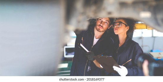 Hispanic Female trainee Mechanics Working Underneath Car Together Car maintenance and auto service garage. Car maintenance and auto service garage concept.  - Powered by Shutterstock