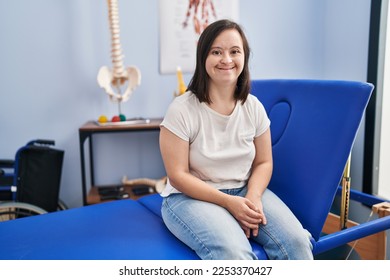 Hispanic girl with down syndrome at physiotherapy clinic looking positive and happy standing and smiling with a confident smile showing teeth  - Shutterstock ID 2253370427