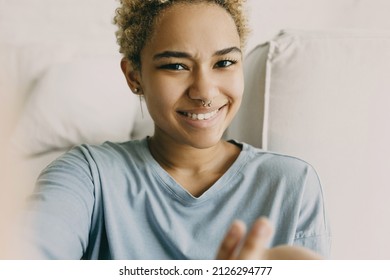 Hispanic Girl See Herself Through Front Facing Camera On Smartphone. Young Latin Woman Talk To Friend On Face Time. Facial Expression, Emotional, Gesture, Technology, Communication Concept